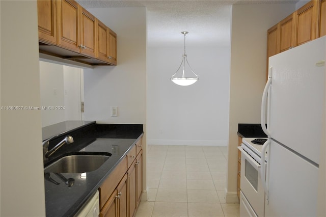 kitchen featuring a textured ceiling, light tile patterned floors, hanging light fixtures, sink, and white appliances