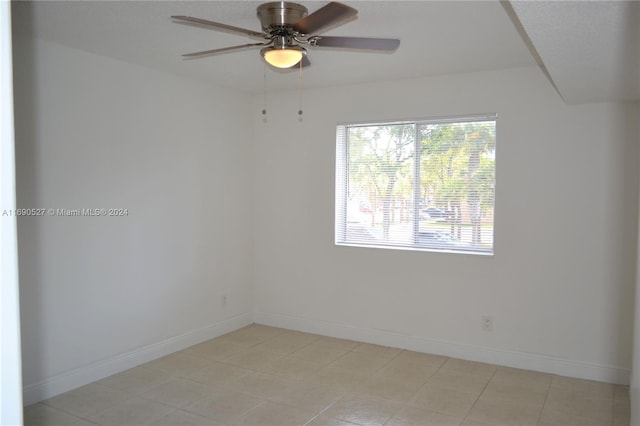 unfurnished room with light tile patterned floors and ceiling fan