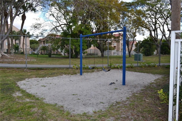 view of jungle gym featuring a lawn