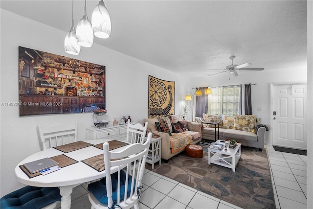 dining area featuring ceiling fan, a textured ceiling, and light tile patterned floors