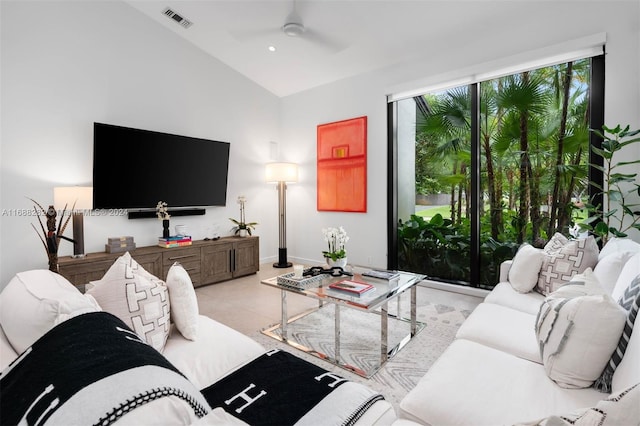 living room featuring ceiling fan and lofted ceiling