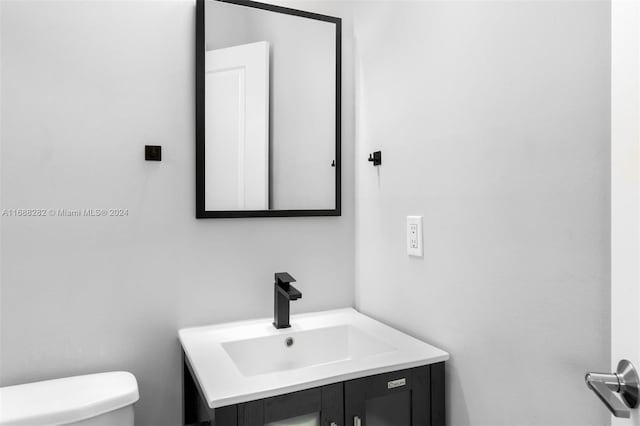 bathroom featuring vanity and toilet