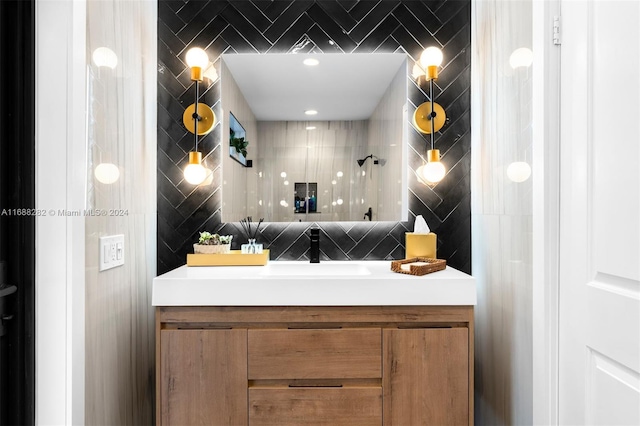 bathroom with walk in shower, tile walls, and vanity