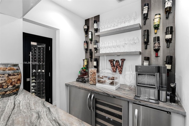 bar with wine cooler and light stone counters