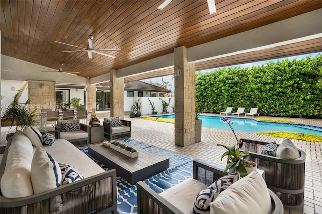 view of patio / terrace with a fenced in pool, ceiling fan, and outdoor lounge area