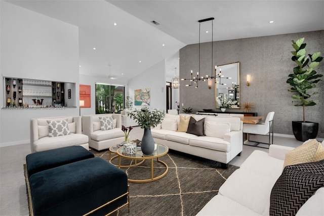 living room featuring a chandelier and high vaulted ceiling