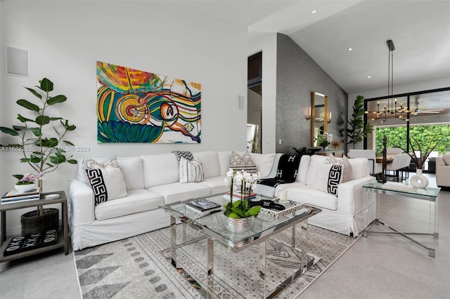 living room featuring lofted ceiling and a chandelier