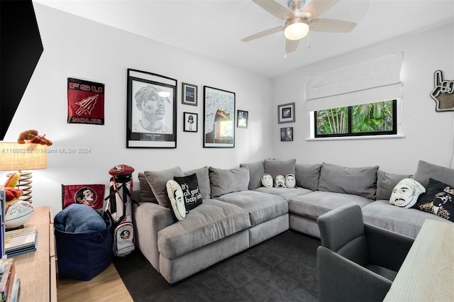 living room featuring wood-type flooring and ceiling fan