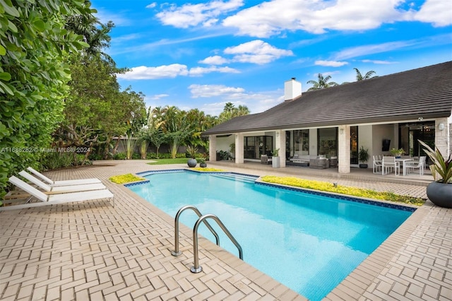 view of swimming pool with a patio