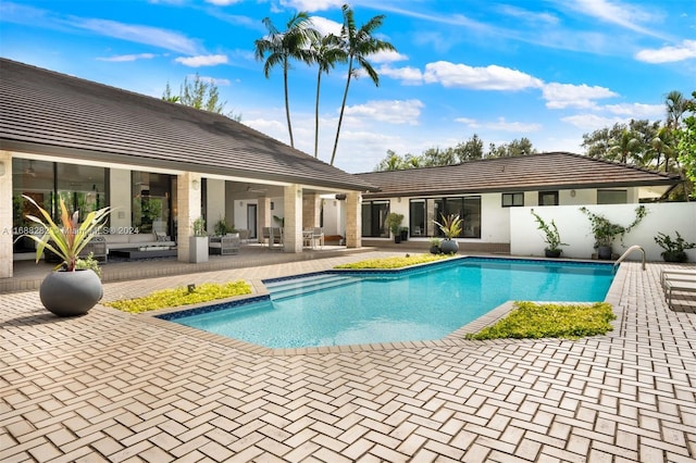 view of swimming pool featuring outdoor lounge area and a patio