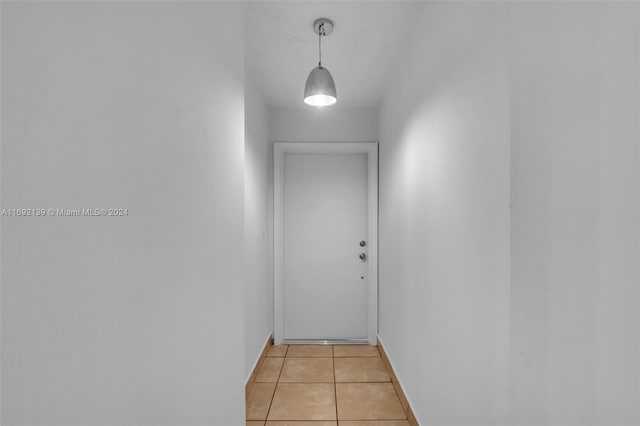 hall featuring light tile patterned flooring