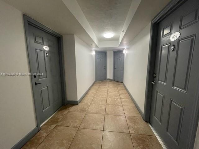 hall with light tile patterned floors