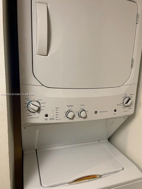 clothes washing area featuring stacked washer and dryer