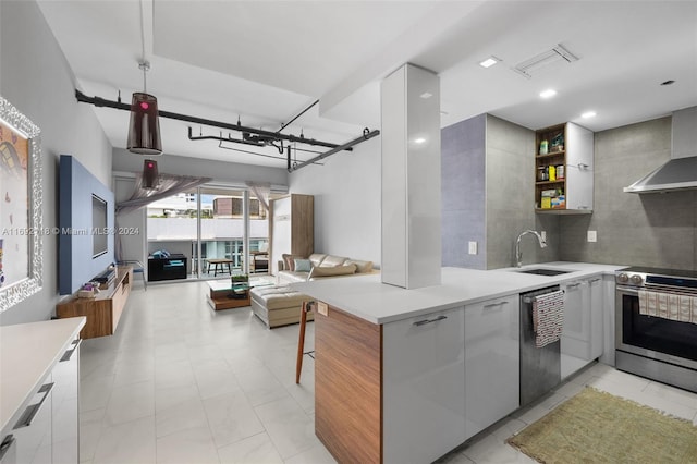 kitchen featuring white cabinets, stainless steel appliances, sink, and wall chimney range hood