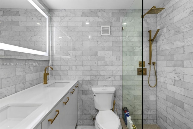 bathroom featuring toilet, vanity, tile walls, and tiled shower