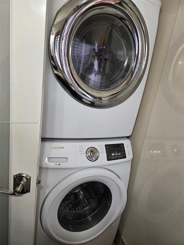 washroom with stacked washer and dryer