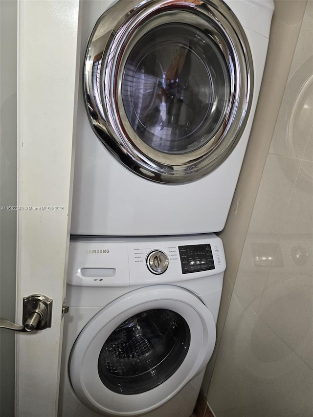 washroom with laundry area and stacked washer / dryer