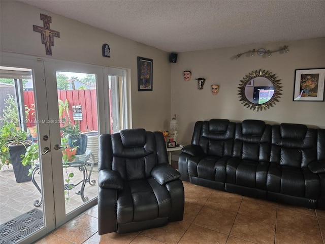living area featuring french doors, a textured ceiling, and tile patterned floors