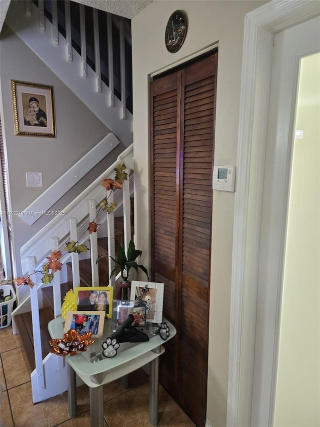 tiled dining area featuring stairs
