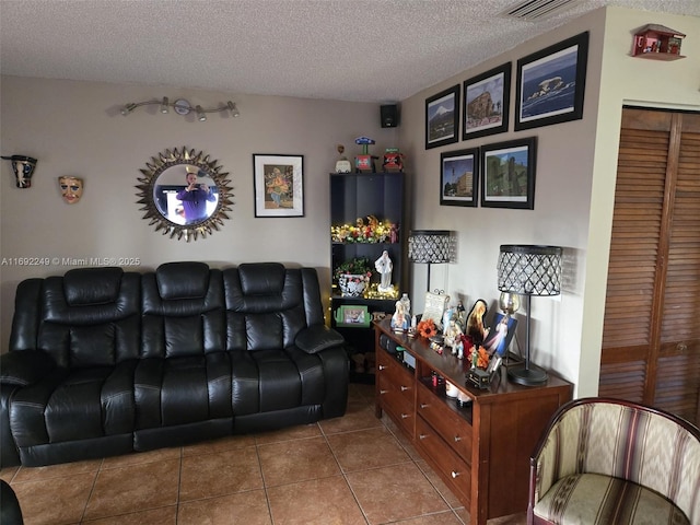 tiled living room featuring a textured ceiling