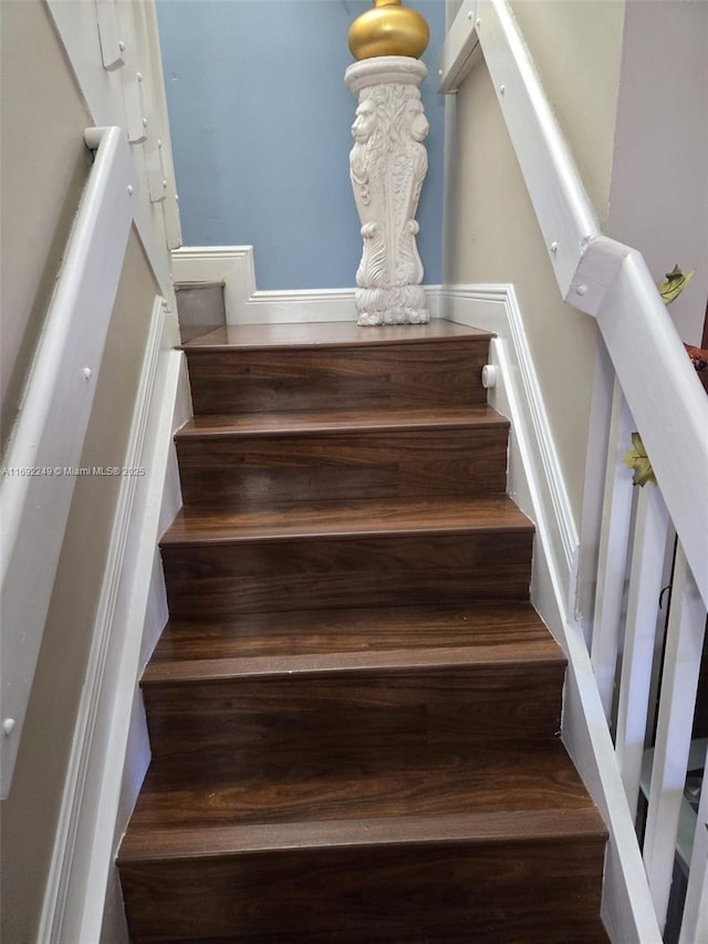 staircase featuring wood finished floors