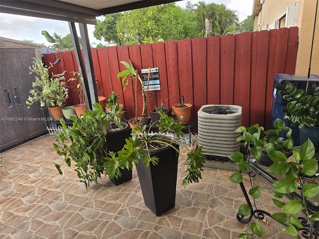 view of patio / terrace featuring fence and cooling unit
