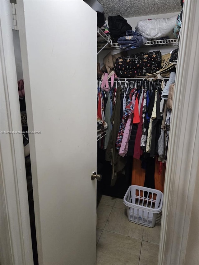 spacious closet featuring light tile patterned floors