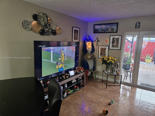 playroom featuring light tile patterned floors and a textured ceiling