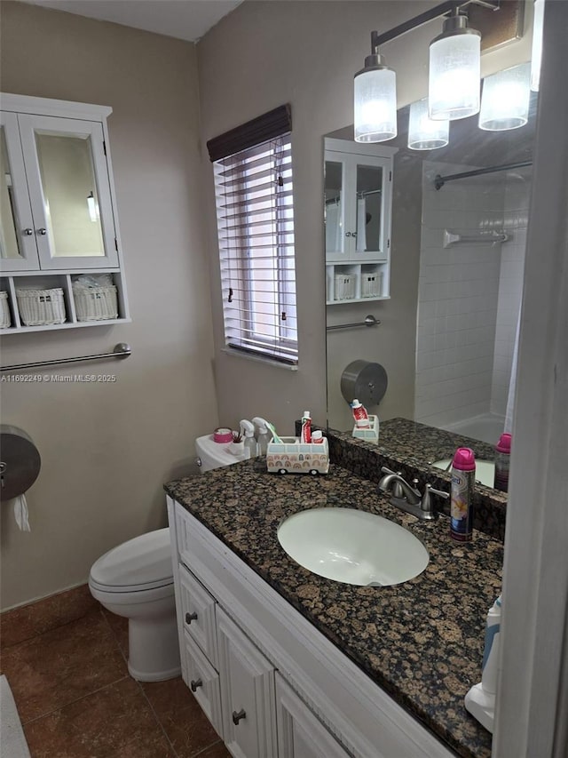 bathroom with vanity, walk in shower, tile patterned floors, and toilet
