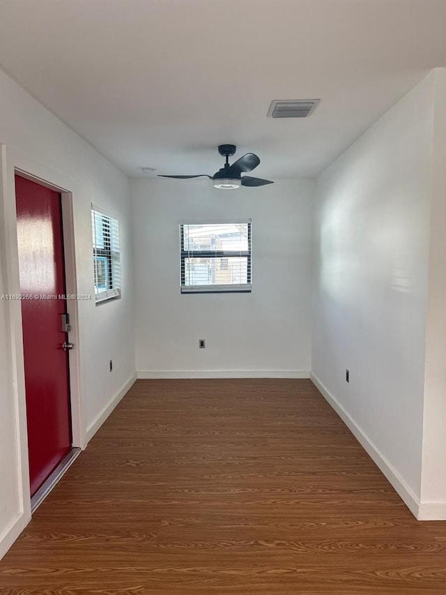 empty room featuring ceiling fan and dark hardwood / wood-style flooring