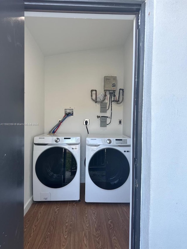 laundry area with dark hardwood / wood-style flooring and separate washer and dryer