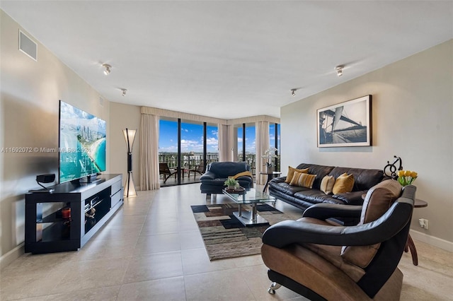 tiled living room with rail lighting and floor to ceiling windows