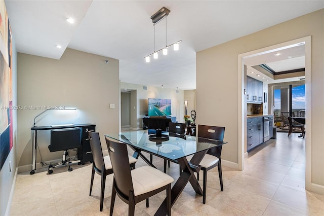 dining room with light tile patterned flooring and a raised ceiling