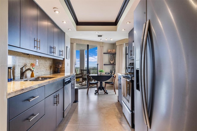 kitchen with crown molding, appliances with stainless steel finishes, a raised ceiling, decorative backsplash, and sink