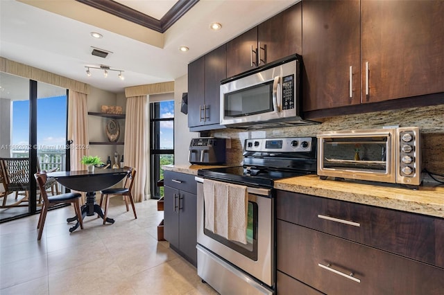 kitchen with stainless steel appliances, dark brown cabinets, decorative backsplash, and crown molding