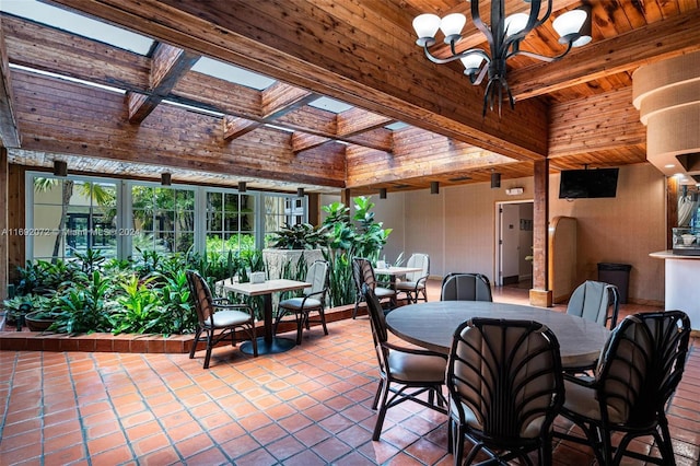 dining area with french doors, tile patterned floors, beam ceiling, wood ceiling, and an inviting chandelier