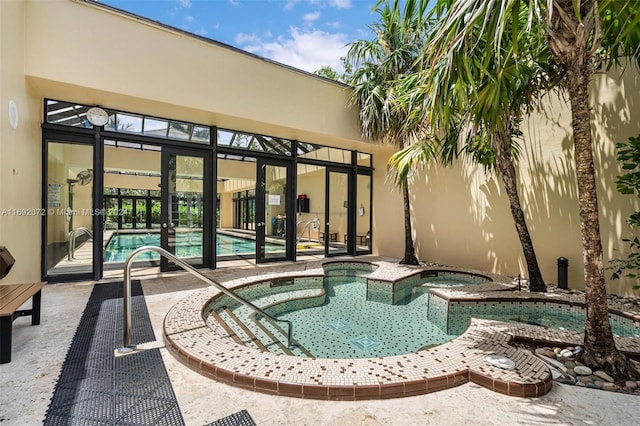 view of swimming pool with an in ground hot tub and a patio area