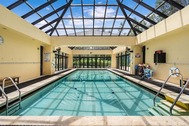 view of pool with glass enclosure