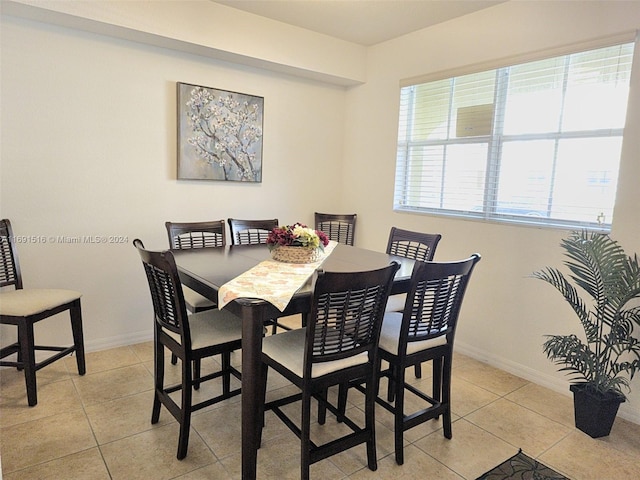 dining space featuring light tile patterned floors