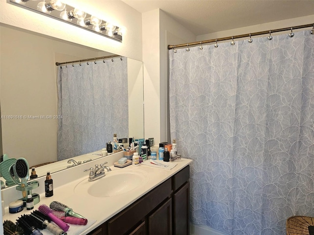 bathroom with vanity, a textured ceiling, and a shower with shower curtain