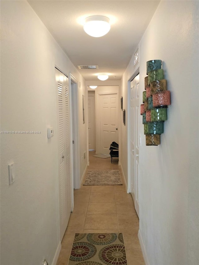 corridor with light tile patterned floors