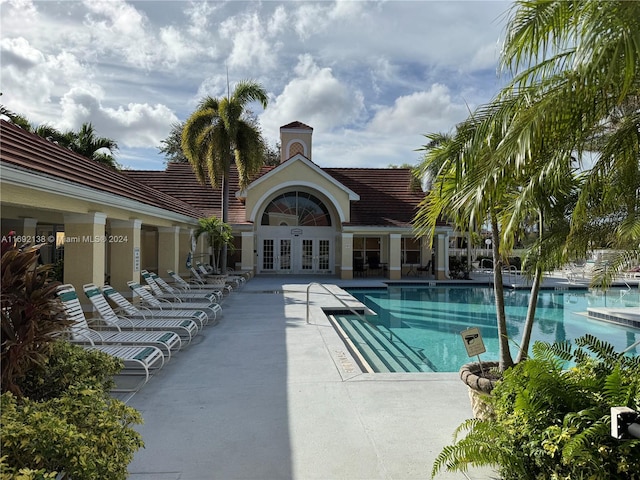 view of pool featuring french doors