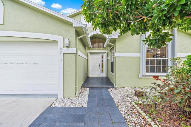 doorway to property featuring a garage