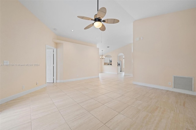 tiled spare room with high vaulted ceiling and ceiling fan