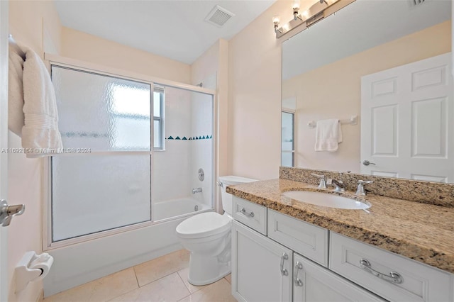 full bathroom with vanity, enclosed tub / shower combo, tile patterned flooring, and toilet