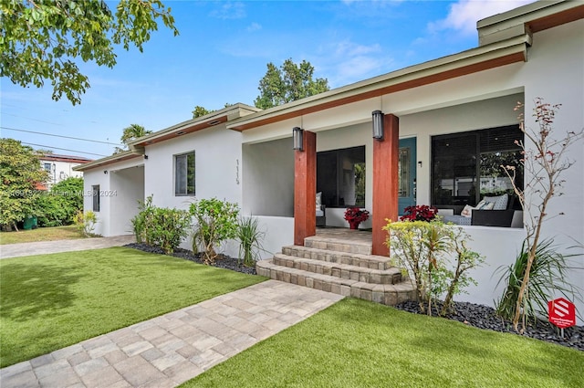 view of front of house with a porch and a front yard