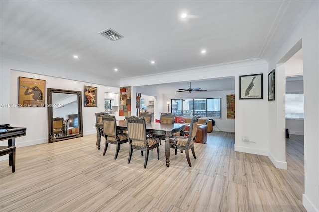 dining room with crown molding, ceiling fan, and light wood-type flooring