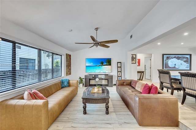 living room featuring vaulted ceiling, light hardwood / wood-style flooring, and ceiling fan