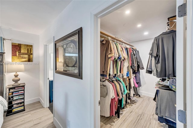 spacious closet with light hardwood / wood-style floors