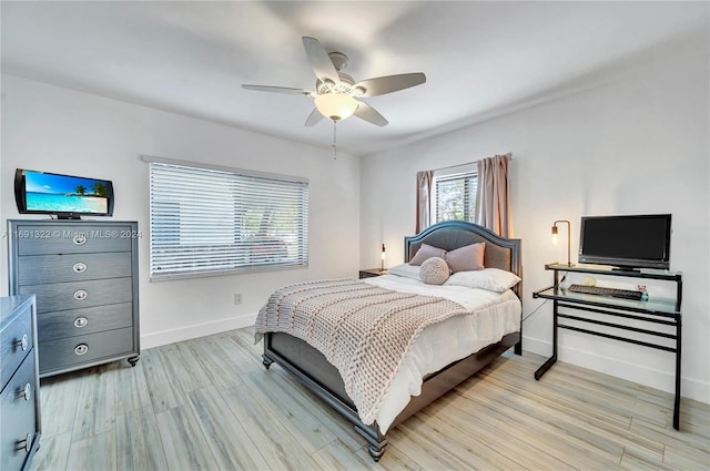 bedroom with ceiling fan and light hardwood / wood-style floors